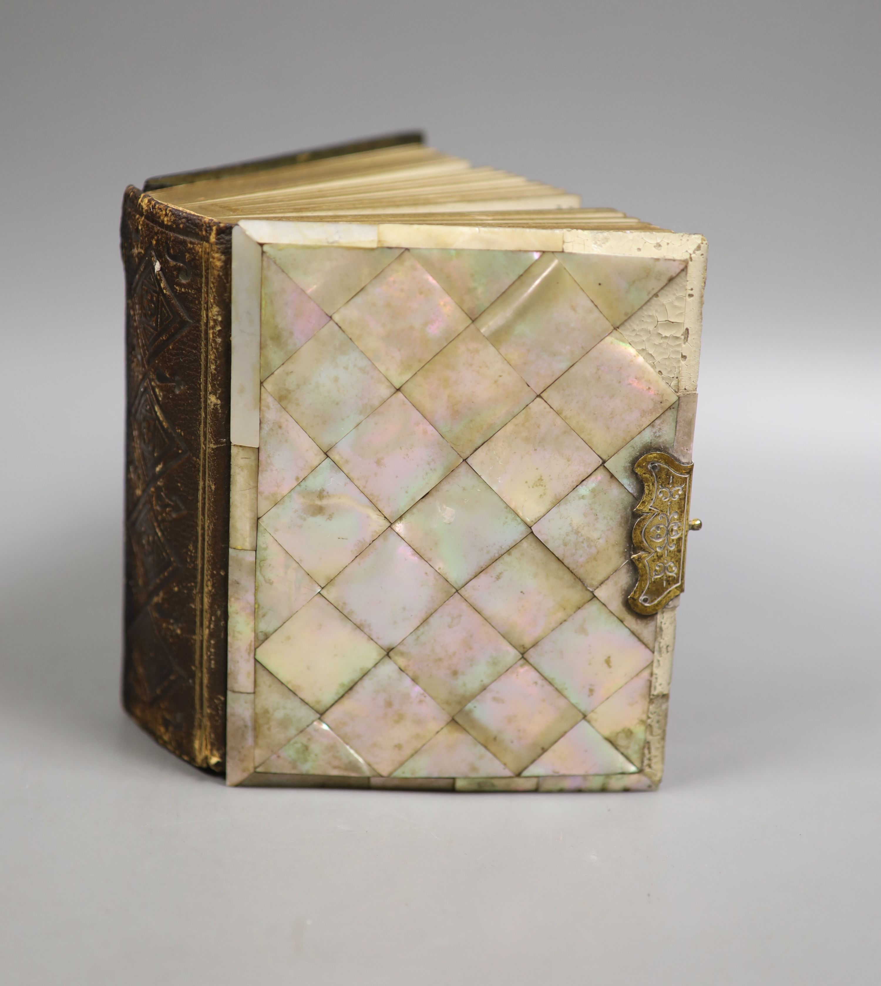 Three Victorian mother of pearl card cases, a papier mache card case and a mother of pearl bound book